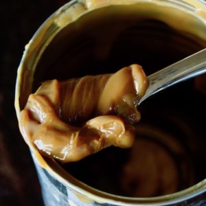 can with spoonful of dulce de leche on top