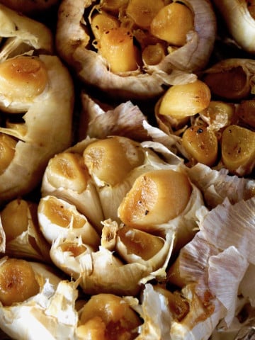 close up of roasted heads of garlic