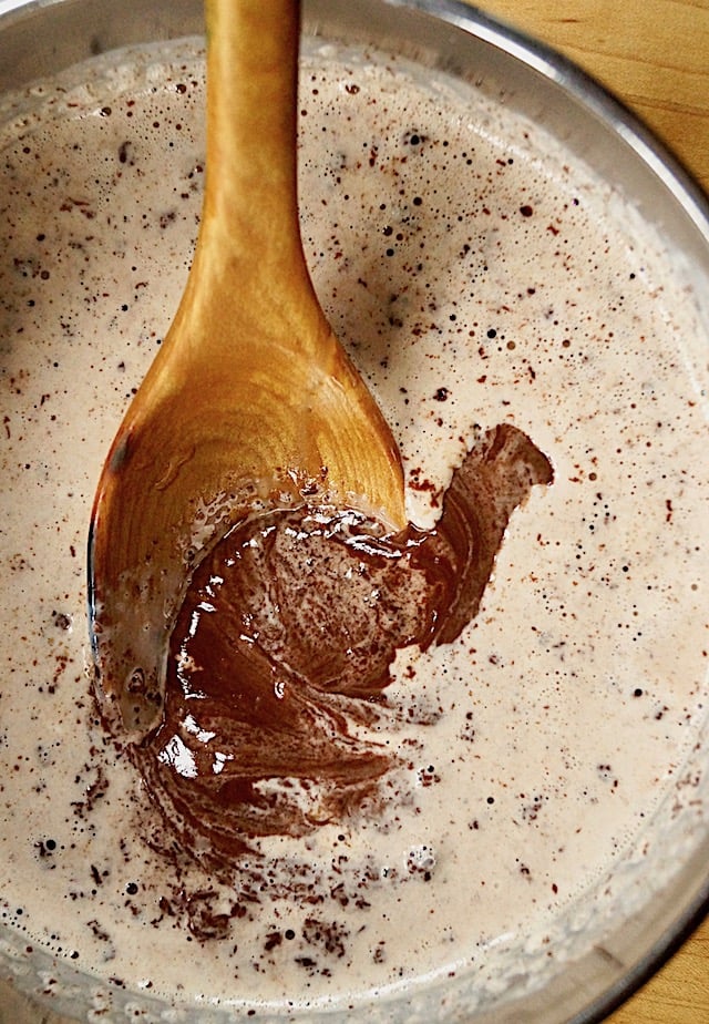 Ganache being mixed with wooden spoon