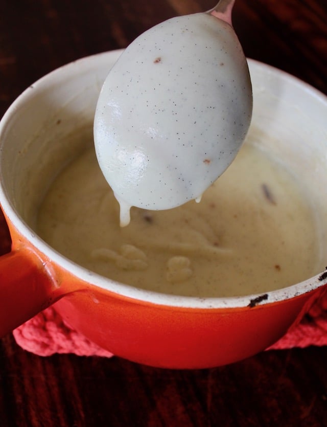vanilla custard coating the back of a large mixing spoon