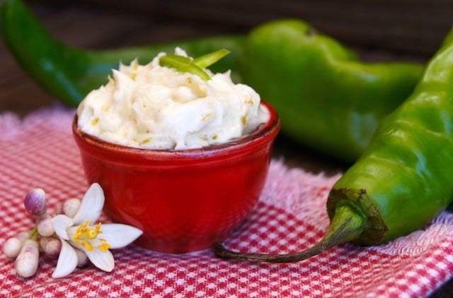 hatch chile butter in a red bowl with green hatch chiles