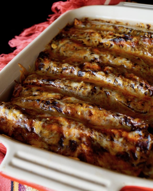 Baking dish filled with freshly baked Best Vegetarian Enchilada Recipe Ever!