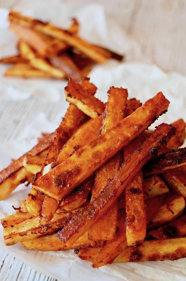 Two piles of Smoky Chipotle French Fries on Parchment