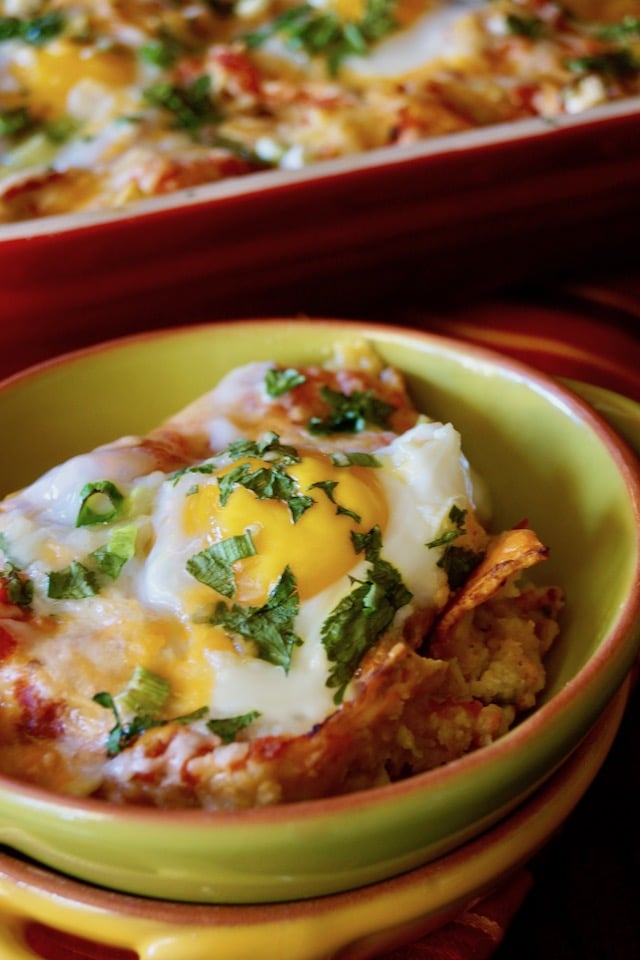 Close up on one serving of Chipotle Breakfast Nachos with Eggs, in a green bowl.