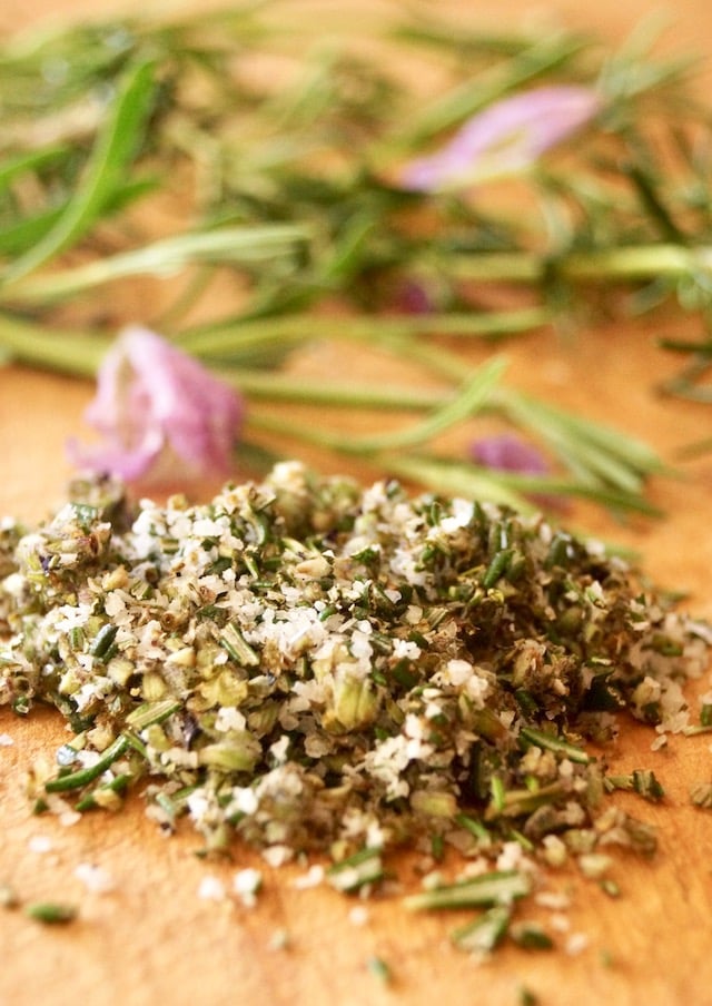 Small pile of rosemary, lavender and salt on a cutting board, for Lavender-Rosemary Grilled Ribeye Steak.