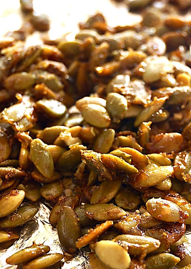 Roasted and Spiced pepitas on a foil-lined baking sheet