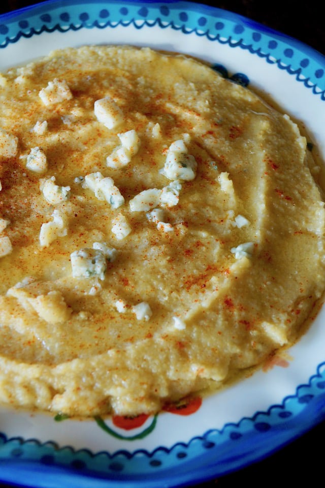 Blue-rimmed bowl with creamy gorgonzola polenta