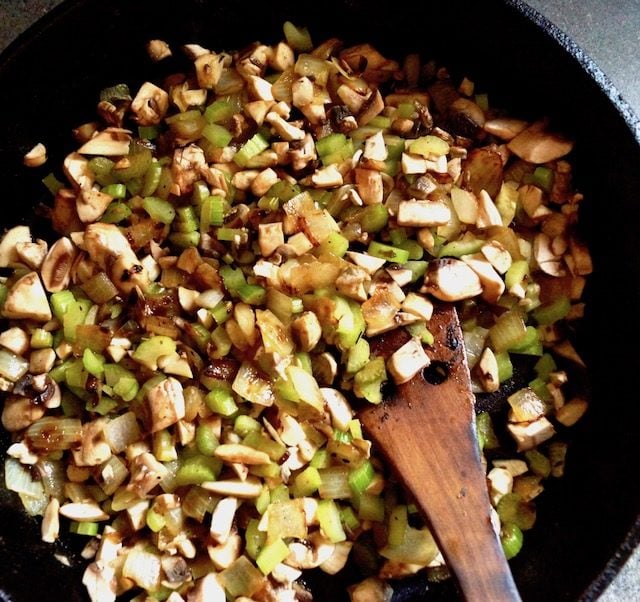 cast iron skillet with finely chopped celery, mushrooms, onions