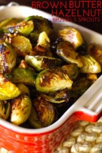 Roasted Brown Butter Hazelnut Brussels Sprouts in small red casserole dish with title on top