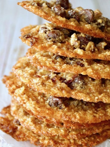 Tall stack of Oatmeal Lace Cookies with white background.