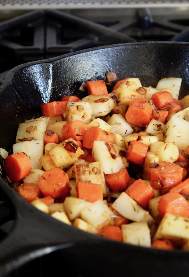 chopped, browned carrots, parsnips and turnips in a casti iron skillet