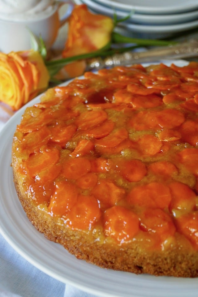 Olive Oil Carrot Cake on a white plate with orange roses.