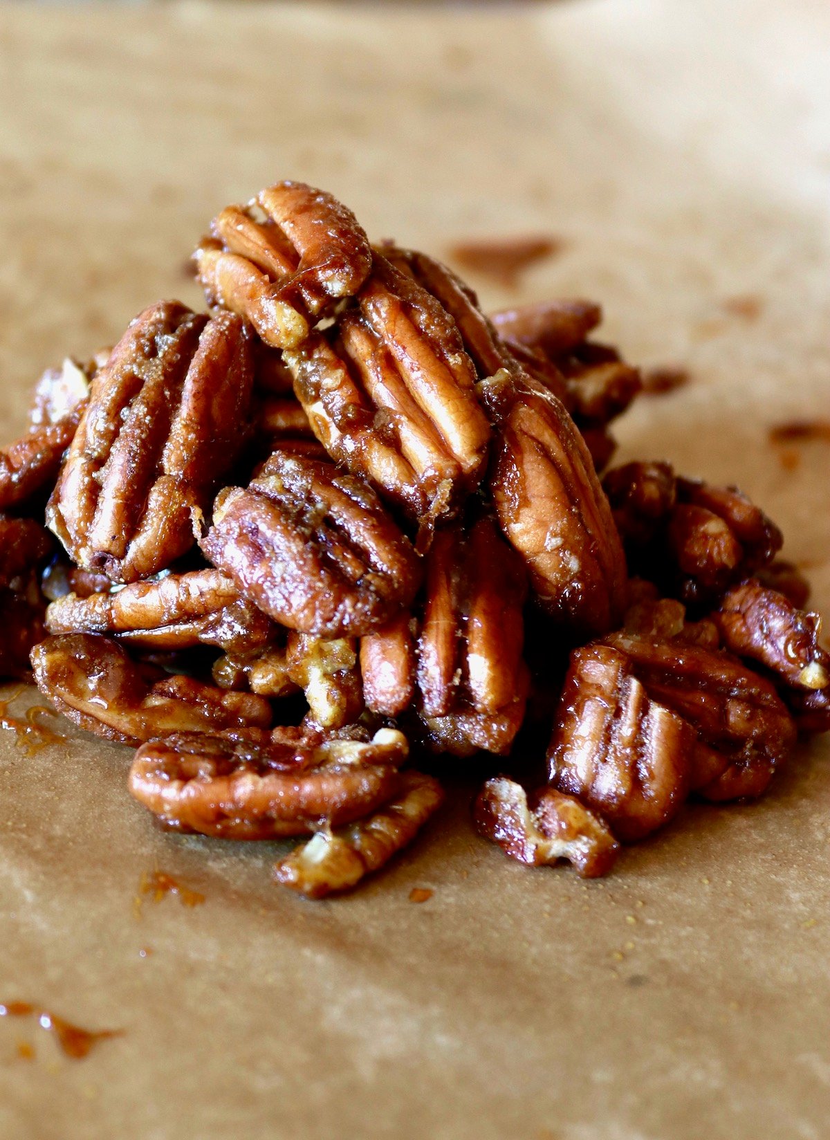 Small pile of caramelized spiced pecans on parchment