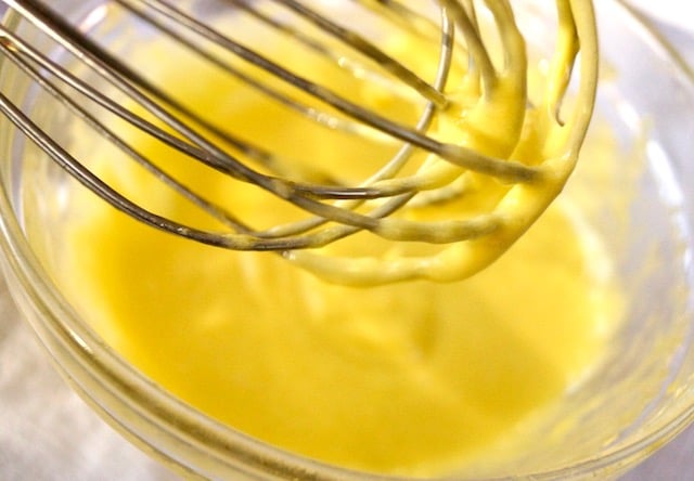 aioli being whisked in glass bowl