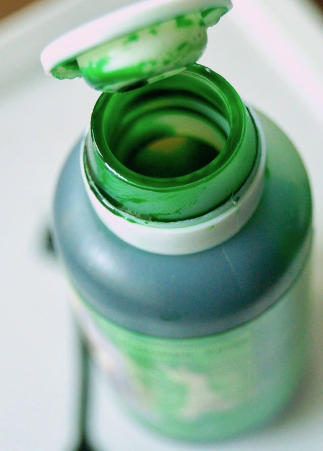 One small bottle of pandan paste with lid open.