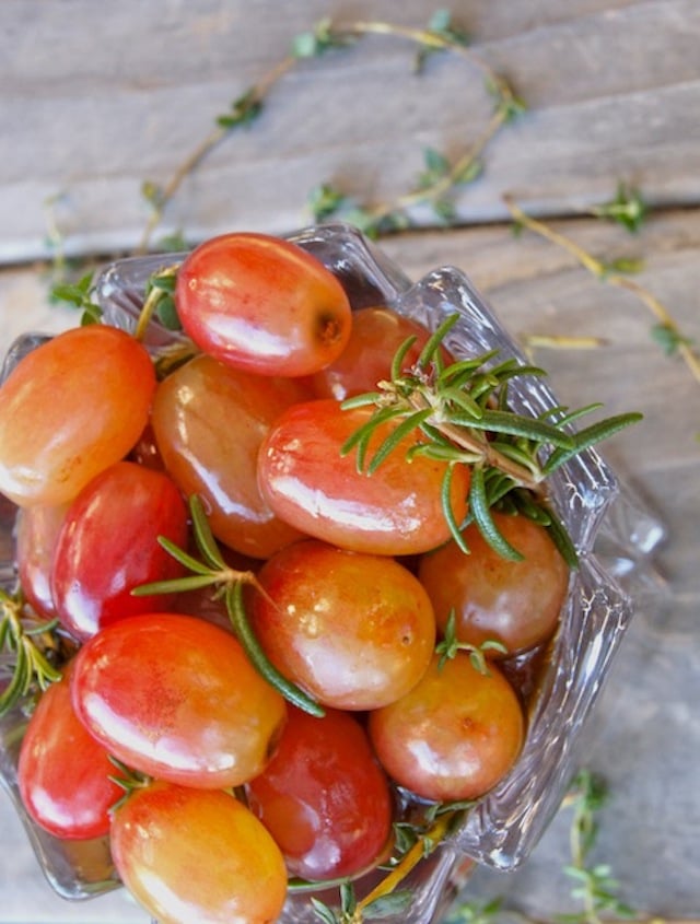 Top view Wine Marinated Grapes in glass with fresh rosemary