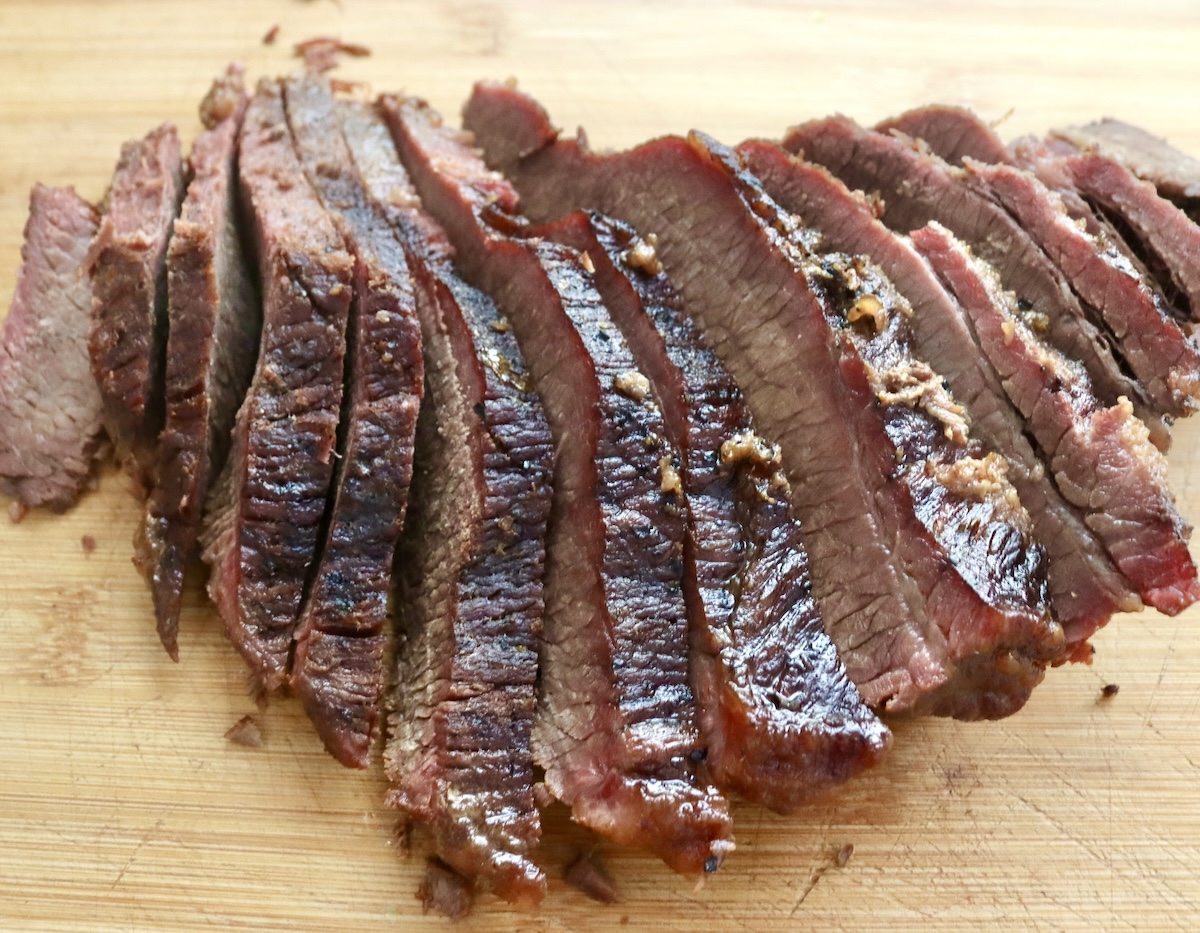 Braised-Brisket-Stew-Recipe Top view of thinly sliced brisket on a cutting board.