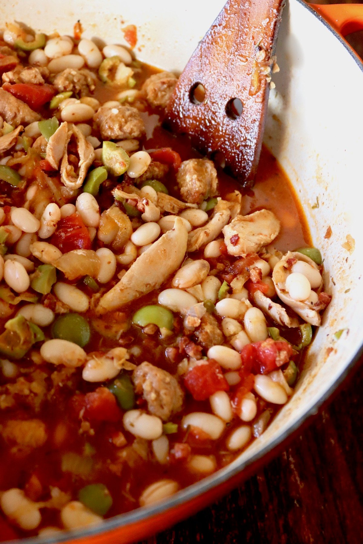 Dutch oven filled with chicken, white beans and tomato