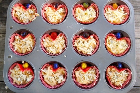Herbs de Provence Idaho Potato Muffin batter in red heart-shaped cupcake liners in a muffin pan