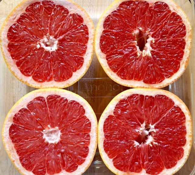 Four Ruby Red grapefruit halves in glass baking dish