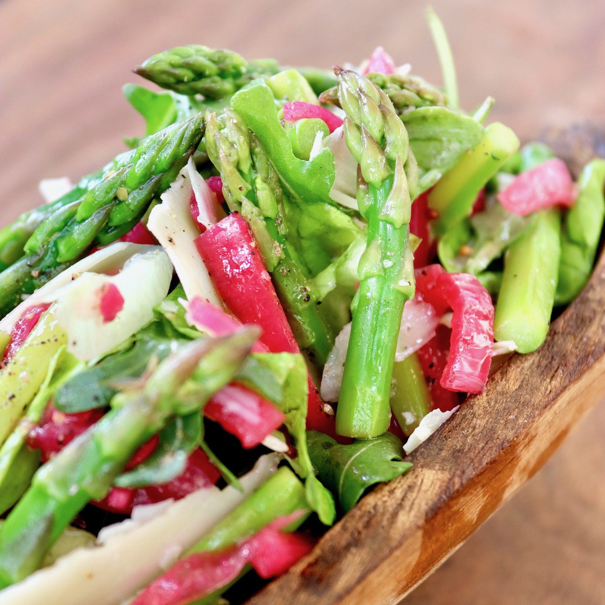 wooden bowl with Parmesan Asparagus salad