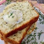 slices of stacked Italian herb bread with butter pat melting on top