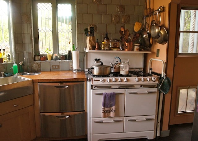 A beautiful kitchen with old fashioned and modern appliances.