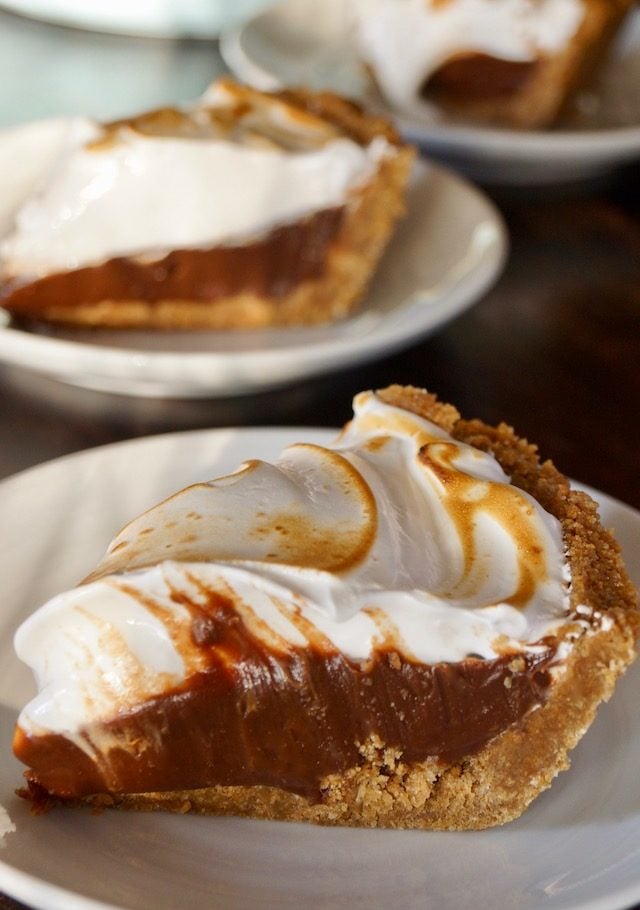 a couple of slices of Peanut Butter Chocolate Meringue Pie on white plates