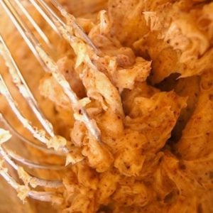 wire whisk in bowl of brown butter