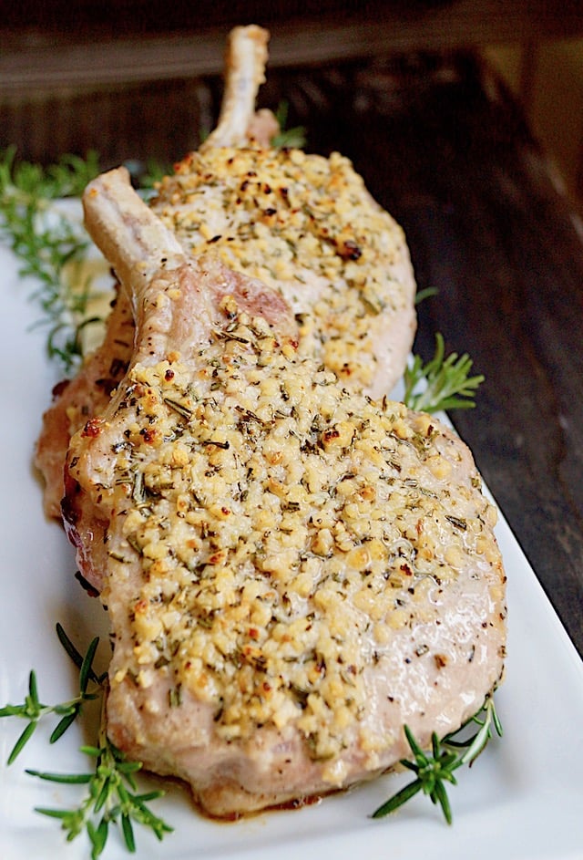 two Garlic Rosemary pork chops on white plate