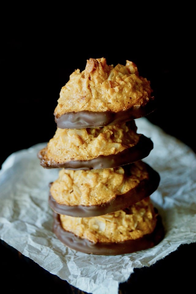 Stack of 4 Salted Dulce de Leche Coconut Macaroons, witht he bottoms covered in chocolate.