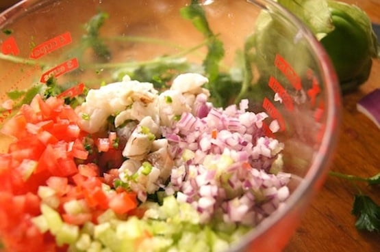 Finely chopped ingredients for Tomatillo Shrimp Ceviche recipe in a large glass measureing beaker.