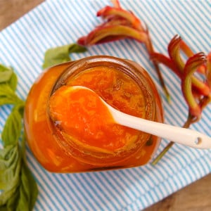 Apricot Basil Preserves in a jar and small white spoon.