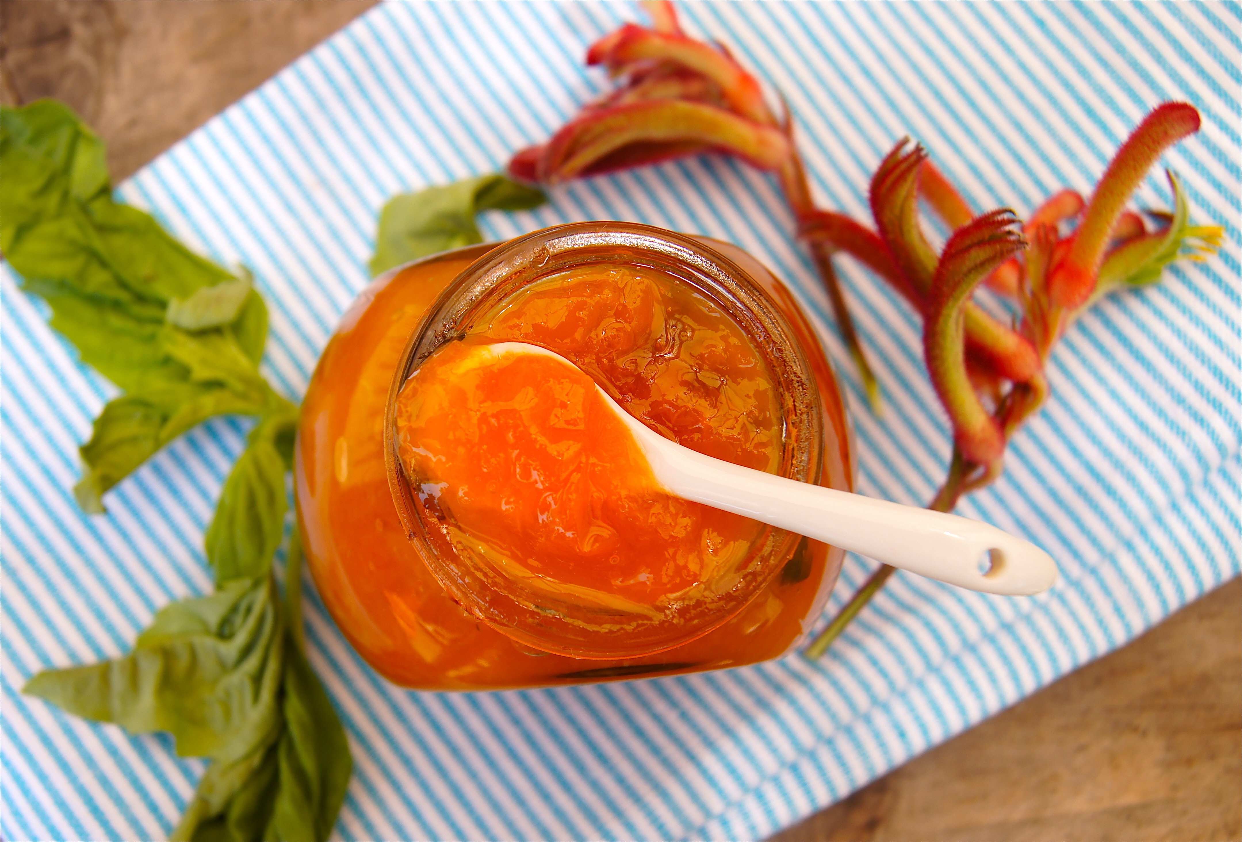 Apricot Basil Preserves in a jar and small white spoon.