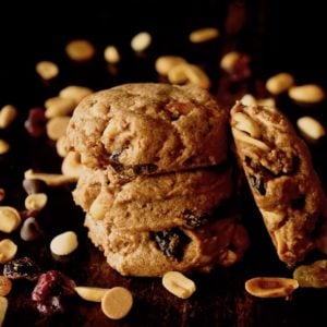 Small stack of Trail MIx Peanut Butter Cookies with trail mix sprinkled around it.