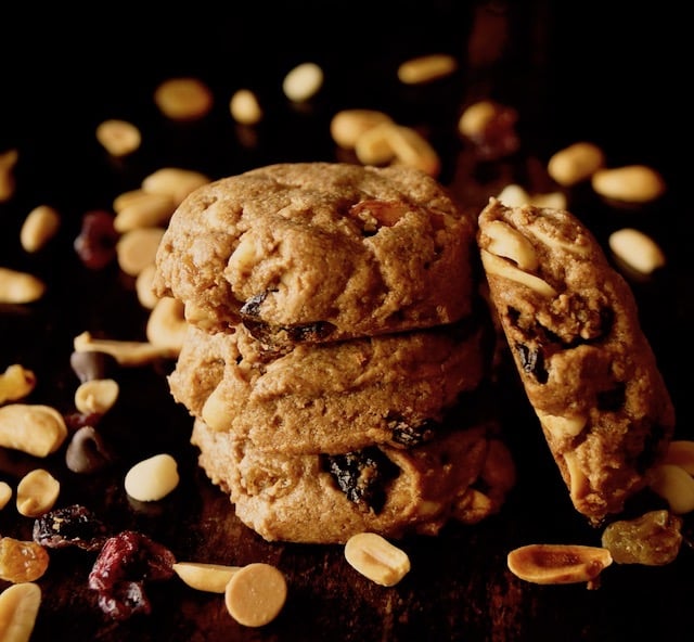 Small stack of Trail MIx Peanut Butter Cookies with trail mix sprinkled around it.