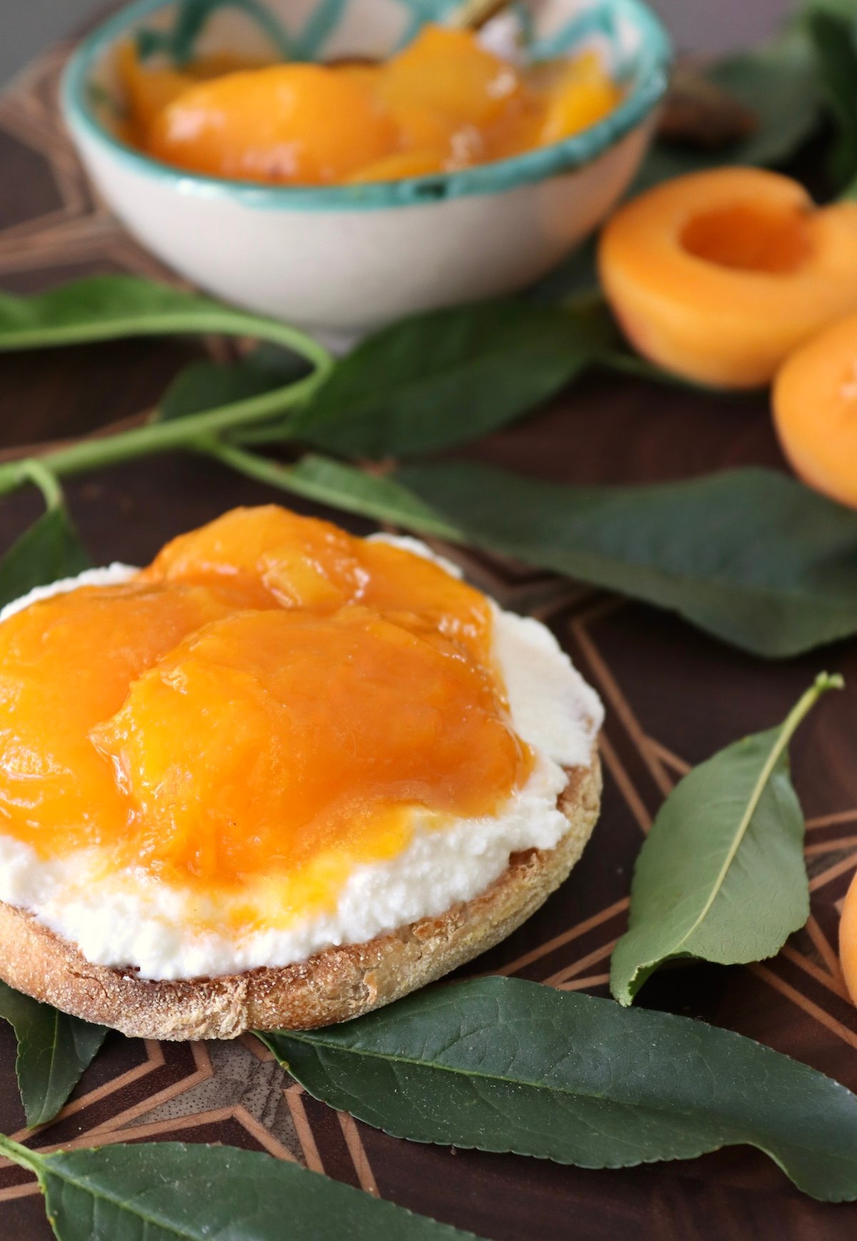 Apricot preserves on English muffin with a spread of ricotta cheese.
