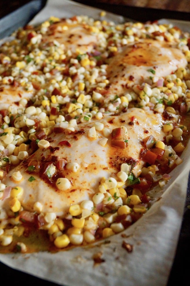 Close up of Sheet Pan Chipotle Chicken with Corn Salsa right oout of the oven on the pan