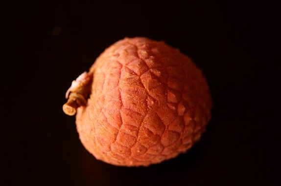 one lychee on black background