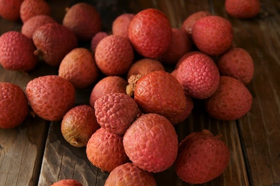 pile of lychees on wooden table