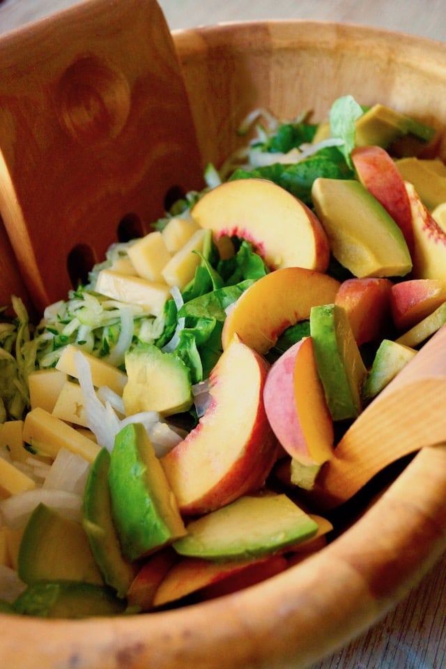 Peach and Avocado Salad with Zucchini in a wooden serving bowl.