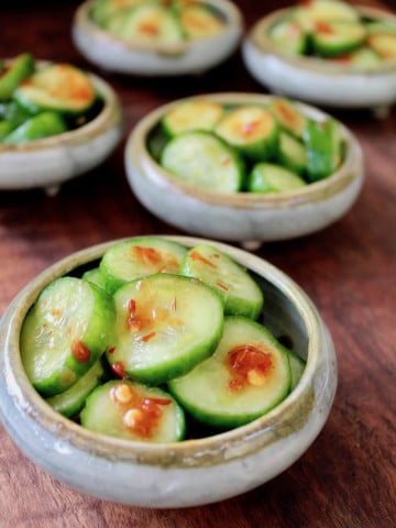 several small bowls of spicy pickled cucumbers