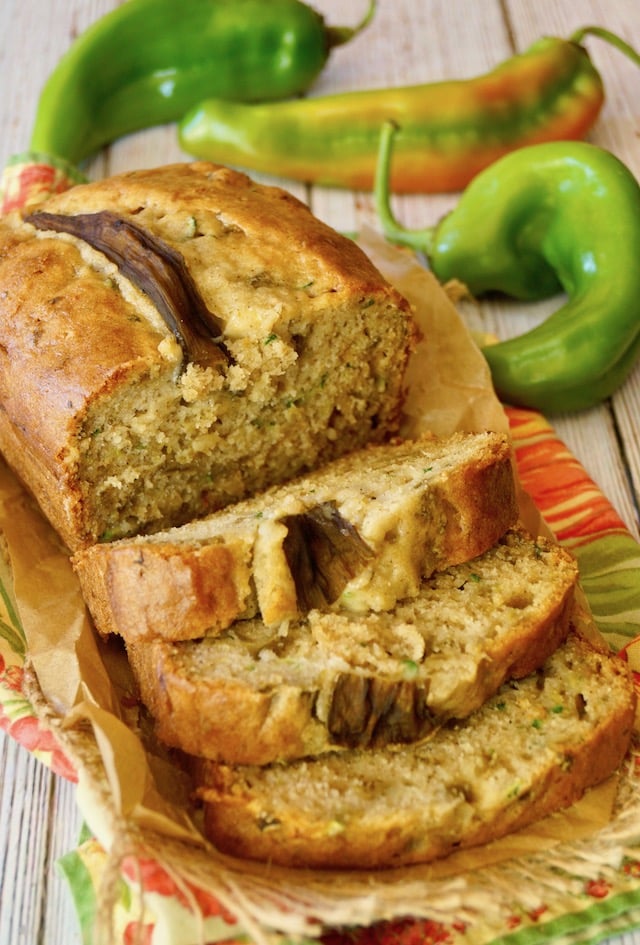 half sliced Hatch Chile Zucchini Bread on red and green cloth