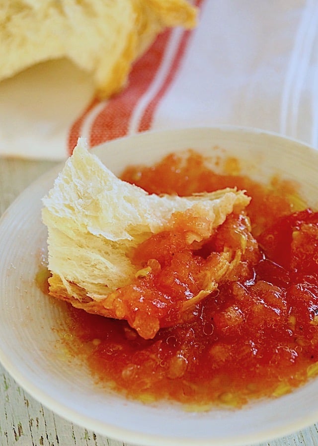 Sweet Breakfast Tomatoes in a white bowl with a piece of bread.