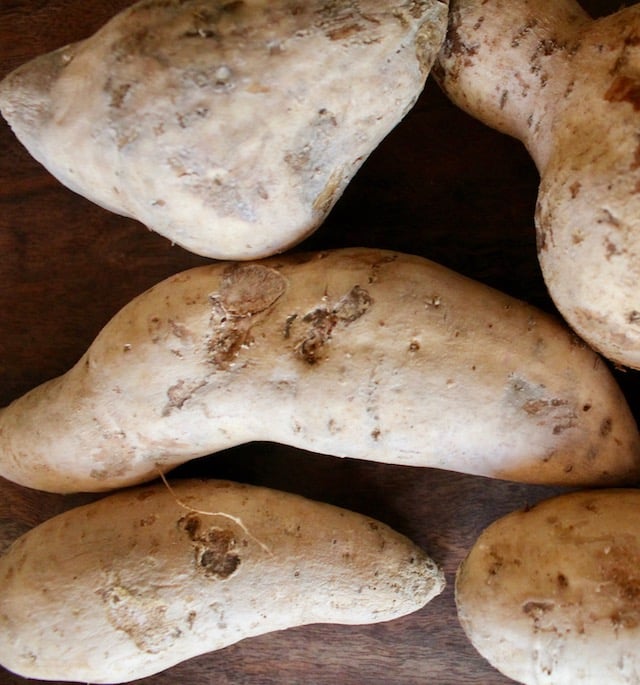 several raw beige potatoes
