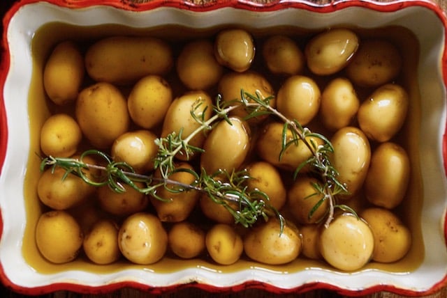 Baby Confit Potatoes in olive oil with rosemary in baking dish