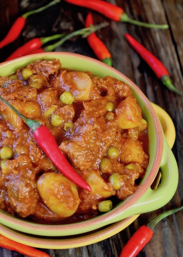 Beef Curry Stew in a green bowl with hot chili on top