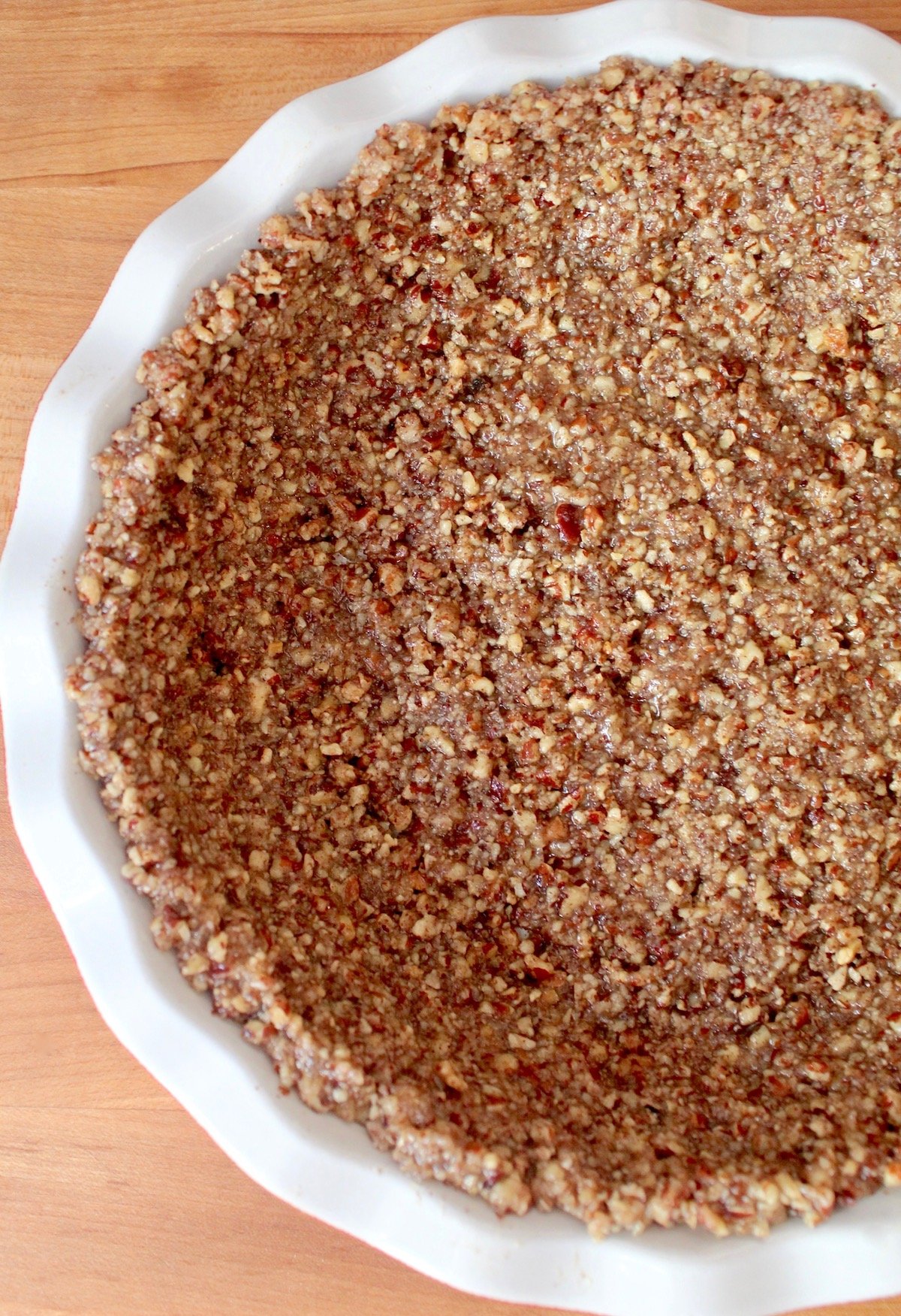 Pecan pie crust in white pie plate