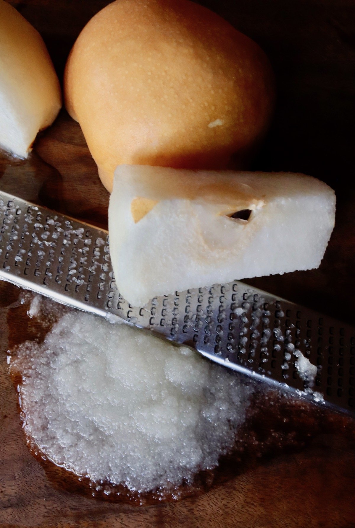 pear puree with microplane zester and whole pear behind it