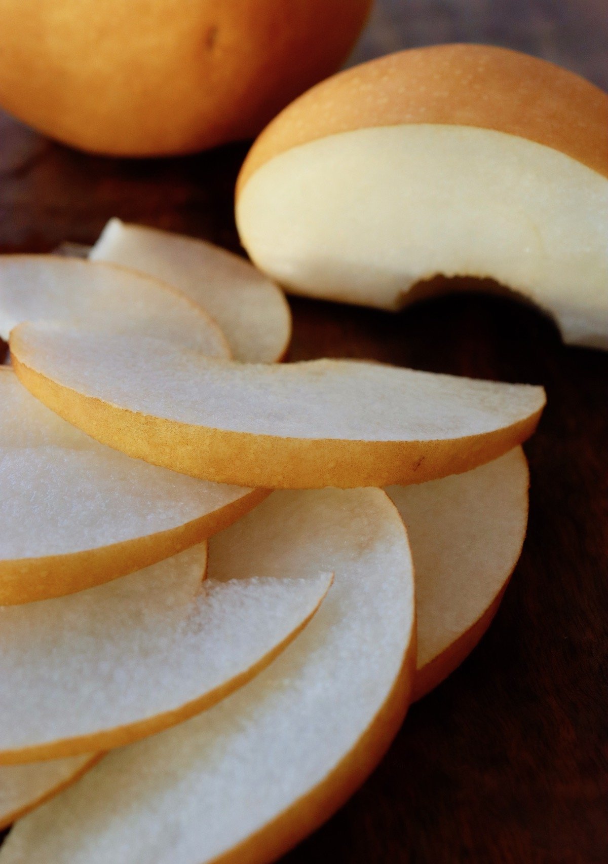 thinly sliced Asian pear on cutting board